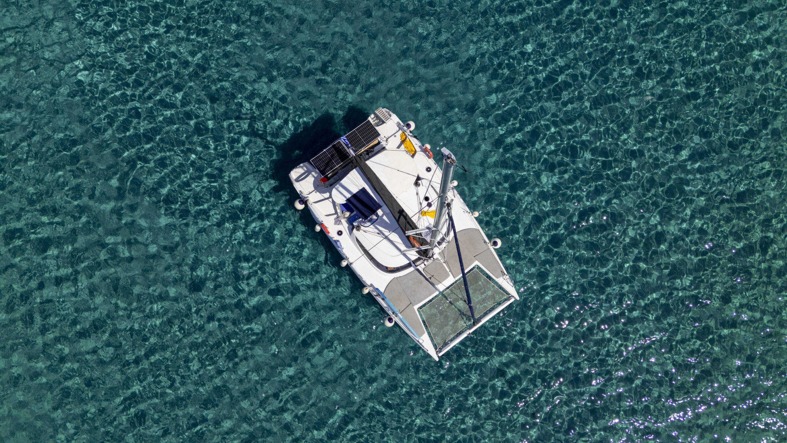 Catamaran Halkidiki — aerial view of catamaran cruising the crystal clear waters of Halkidiki