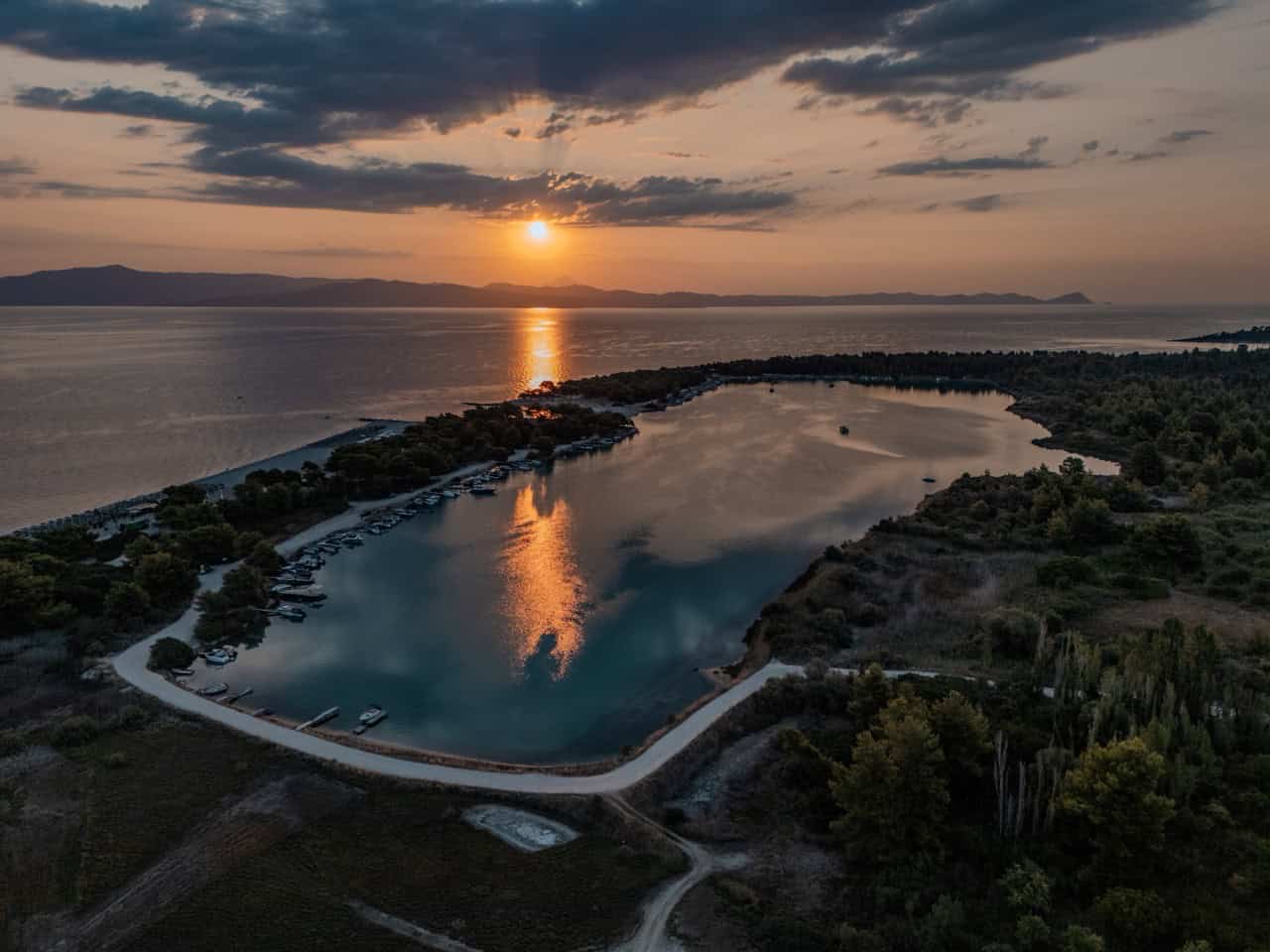 Sailing Kassandra — Glarokavos harbour at sunrise, aerial drone view, Halkidiki